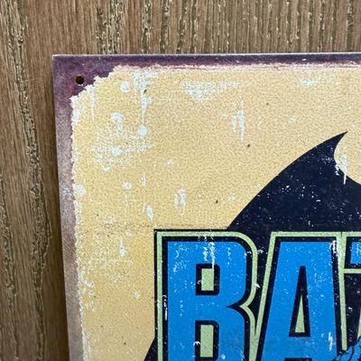 Sale Photo Thumbnail #166: Painted metal sign with an image of the classic 1930’s DC comics Batman. Image is distressed to make it look old.