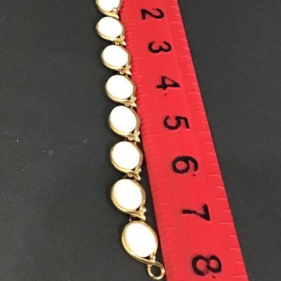 Vintage gold tone bracelet with white cabachon