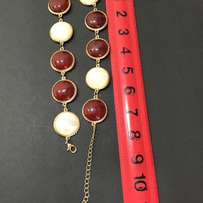 Gold tone necklace with white and maroon Cabachon