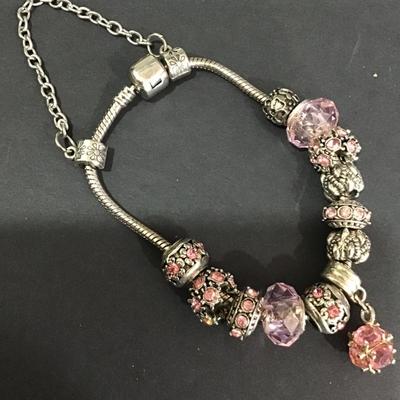 Silver tone bracelet with pink rhinestone charms