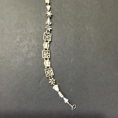 Silver tone charm bracelet with crystals and multi color rhinestones