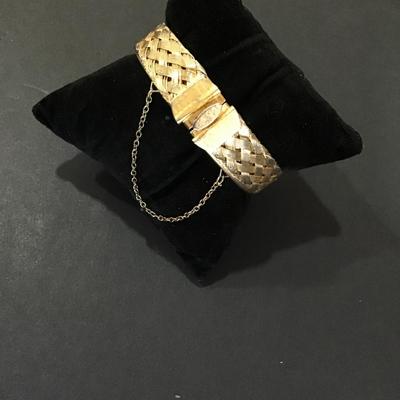 Gold tone meshed, hinged bracelet