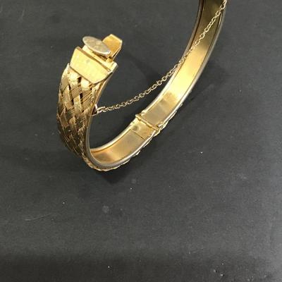 Gold tone meshed, hinged bracelet