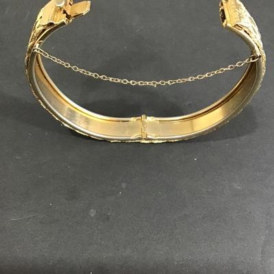 Gold tone meshed, hinged bracelet