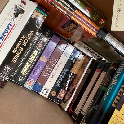 Sale Photo Thumbnail #388: A box DVDs and VHS tapes