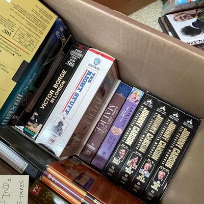 Sale Photo Thumbnail #389: A box DVDs and VHS tapes