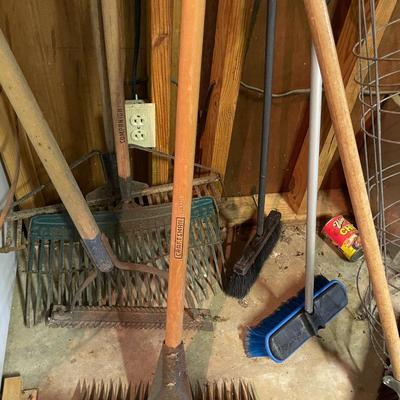 Sale Photo Thumbnail #856: Rake & Broom Lot includes various sized metal rakes, brooms, & tomato cages