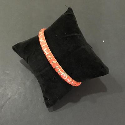 Gold tone, bangle bracelet with Reddish pink enamel