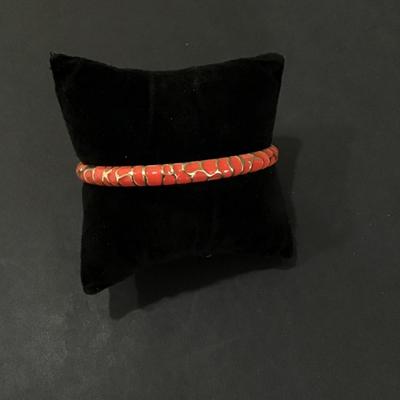 Gold tone, bangle bracelet with Reddish pink enamel