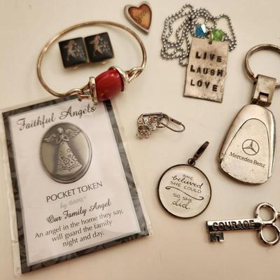 Sale Photo Thumbnail #177: This auction lot is for what is Still in the Jewelry Box.  This gathering offers a pair of Siamese-style earrings, a small token heart, a Mercedes key fob, a Courage Key, a nifty pair of Cubic Zirconia earrings, a stainless steel chain with a slogan penda