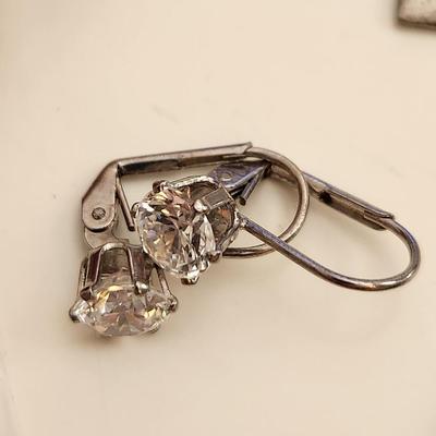 Sale Photo Thumbnail #178: This auction lot is for what is Still in the Jewelry Box.  This gathering offers a pair of Siamese-style earrings, a small token heart, a Mercedes key fob, a Courage Key, a nifty pair of Cubic Zirconia earrings, a stainless steel chain with a slogan penda
