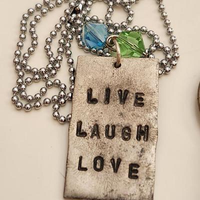 Sale Photo Thumbnail #180: This auction lot is for what is Still in the Jewelry Box.  This gathering offers a pair of Siamese-style earrings, a small token heart, a Mercedes key fob, a Courage Key, a nifty pair of Cubic Zirconia earrings, a stainless steel chain with a slogan penda