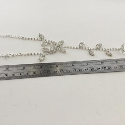 Silver tone bracelet with attached ring adjustable