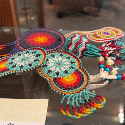 Sale Photo Thumbnail #638: Entire shelf full of Native American beaded pieces