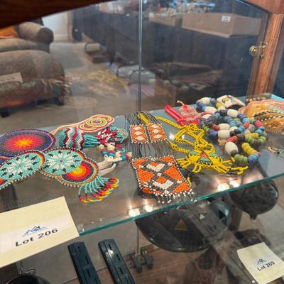 Sale Photo Thumbnail #637: Entire shelf full of Native American beaded pieces