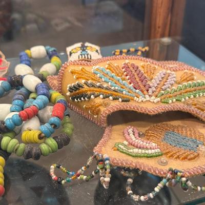 Sale Photo Thumbnail #640: Entire shelf full of Native American beaded pieces