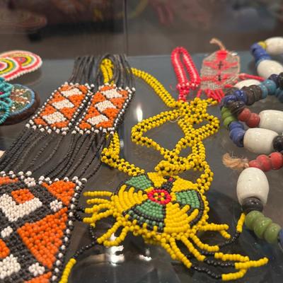 Sale Photo Thumbnail #639: Entire shelf full of Native American beaded pieces