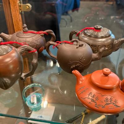 Sale Photo Thumbnail #853: A collection of 11 different ceramic Tea Pots as shown