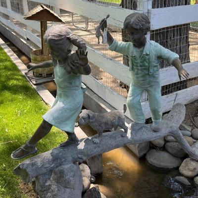 Sale Photo Thumbnail #1457: Cute outdoor Bronze w/2 kids & dog on it 5’l x 5t est.
This item will require special logistics to remove it from the yard. We are not loading or transporting these large items. They must be removed carefully not to disturb the surroundings.
