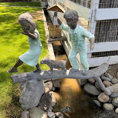 Sale Photo Thumbnail #1461: Cute outdoor Bronze w/2 kids & dog on it 5’l x 5t est.
This item will require special logistics to remove it from the yard. We are not loading or transporting these large items. They must be removed carefully not to disturb the surroundings.