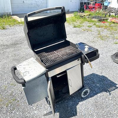 Sale Photo Thumbnail #1407: Comes with grill cover, condition is fair; had prior use.
Has burner rack on back with grill brush and propane hook up hose