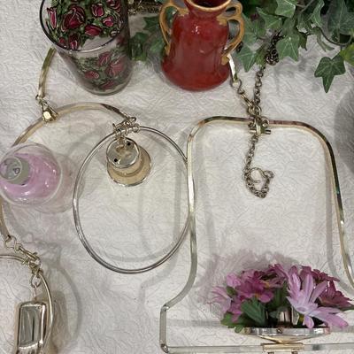 Brass hanging decor, candles, and floral arrangements