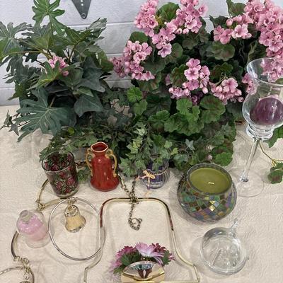 Brass hanging decor, candles, and floral arrangements