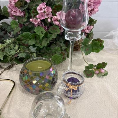 Brass hanging decor, candles, and floral arrangements