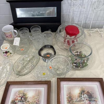 Black shelf, plate rack, dishes, and art