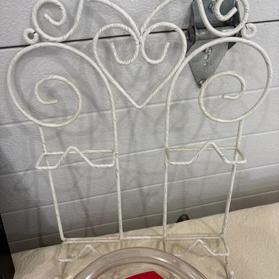 Black shelf, plate rack, dishes, and art