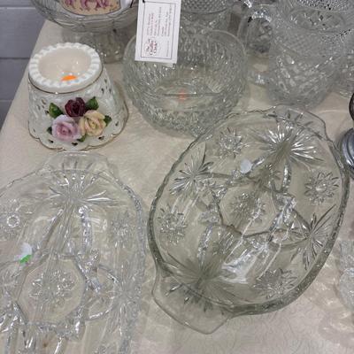 Black shelf, plate rack, dishes, and art