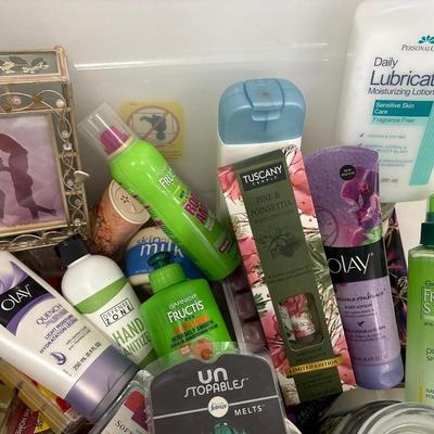 Yoga mat, tote full of lotions and hair product and candle melt