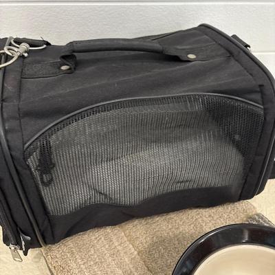 Small dog carrier, dog bowl, and rug