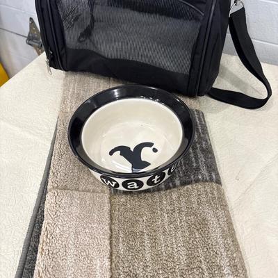 Small dog carrier, dog bowl, and rug