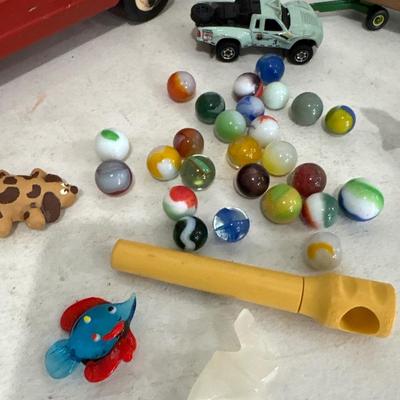 Toy car, marbles, and marble elephant