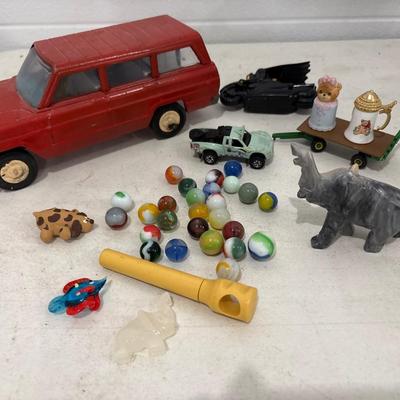 Toy car, marbles, and marble elephant