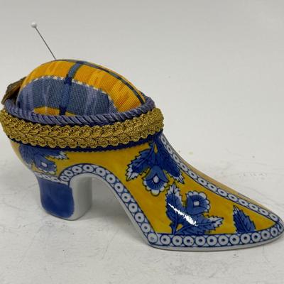 Sale Photo Thumbnail #391: Originally a ceramic planter or vase, decorated and modified to be a pincushion. Good condition, approx. 7" long and 4" high.