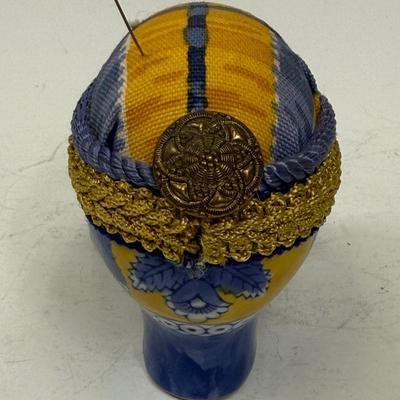 Sale Photo Thumbnail #389: Originally a ceramic planter or vase, decorated and modified to be a pincushion. Good condition, approx. 7" long and 4" high.