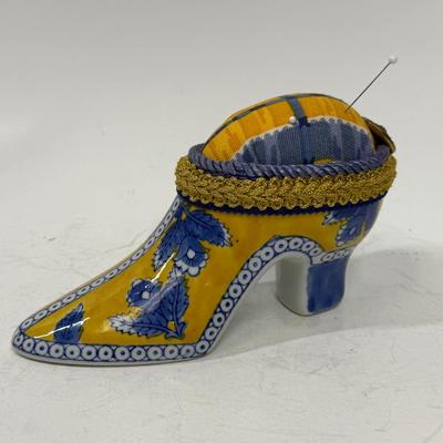 Sale Photo Thumbnail #390: Originally a ceramic planter or vase, decorated and modified to be a pincushion. Good condition, approx. 7" long and 4" high.