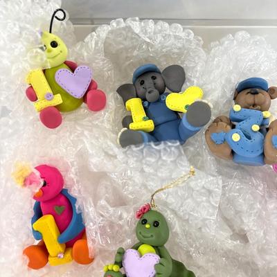 Polymer clay figurines with rug mats in tote