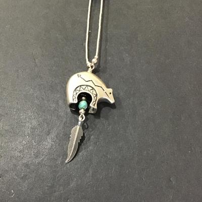 Silver tone necklace with turquoise type stone with bear wind, chime pendant
