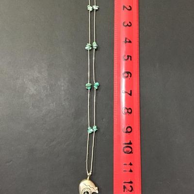 Silver tone necklace with turquoise type stone with bear wind, chime pendant