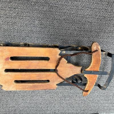 Sale Photo Thumbnail #423: Wood with wrought iron metalwork and runners.  Not an actual sled, but made as a display piece with large dolls or stuffed animals. Good condition.