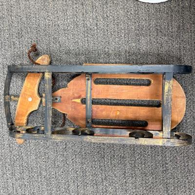 Sale Photo Thumbnail #421: Wood with wrought iron metalwork and runners.  Not an actual sled, but made as a display piece with large dolls or stuffed animals. Good condition.