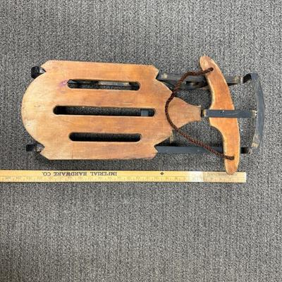 Sale Photo Thumbnail #420: Wood with wrought iron metalwork and runners.  Not an actual sled, but made as a display piece with large dolls or stuffed animals. Good condition.