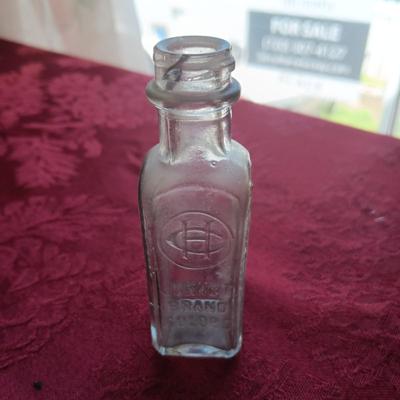 AN ASSORTMENT OF ANTIQUE BOTTLES WITH RAISED LETTERING