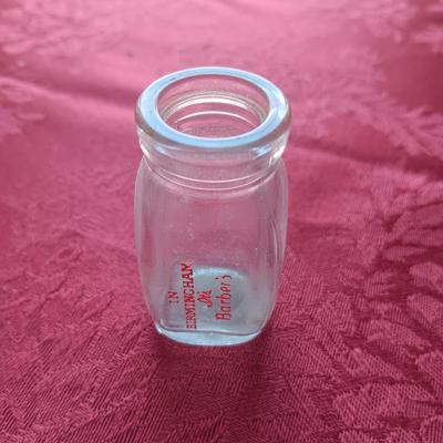 AN ASSORTMENT OF ANTIQUE BOTTLES WITH RAISED LETTERING