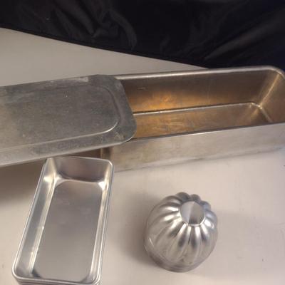 Collection of Metal Molds with Covered Refrigerator Container