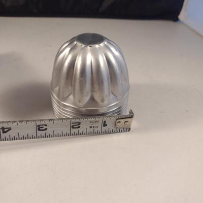Collection of Metal Molds with Covered Refrigerator Container
