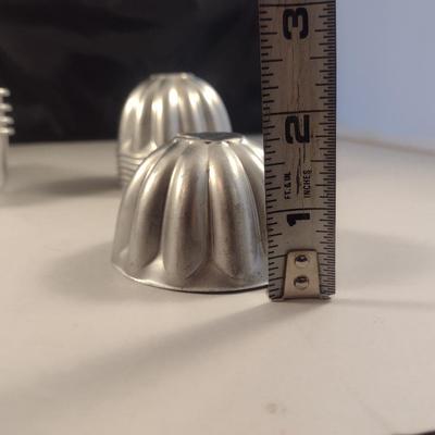 Collection of Metal Molds with Covered Refrigerator Container